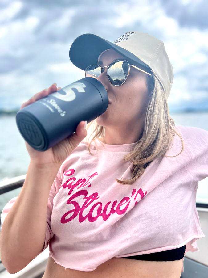 Guest in a pink Capt. Stove's t-shirt with a logo tumbler