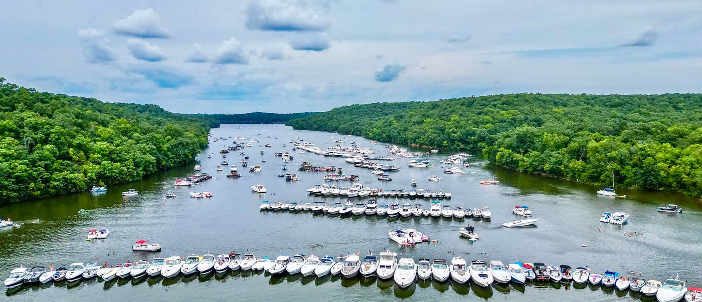 Aerial view of hundreds of boats rafted together in Party Cove at Lake of the Ozarks