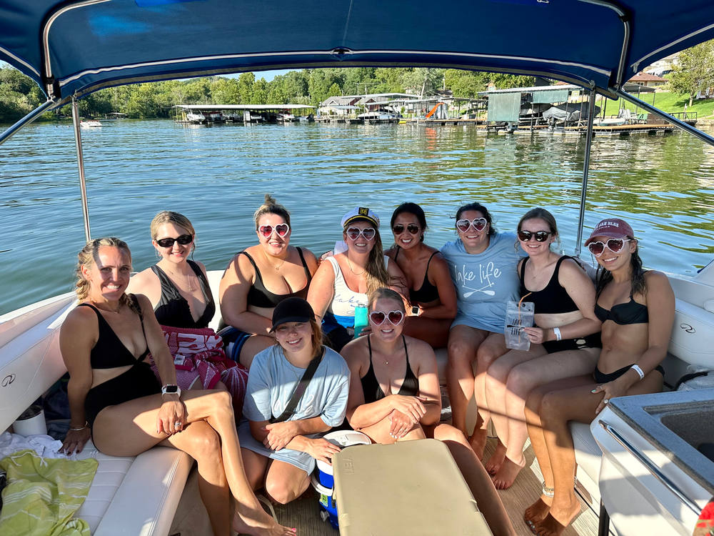 Eleven guests seated in the shade of the bimini top